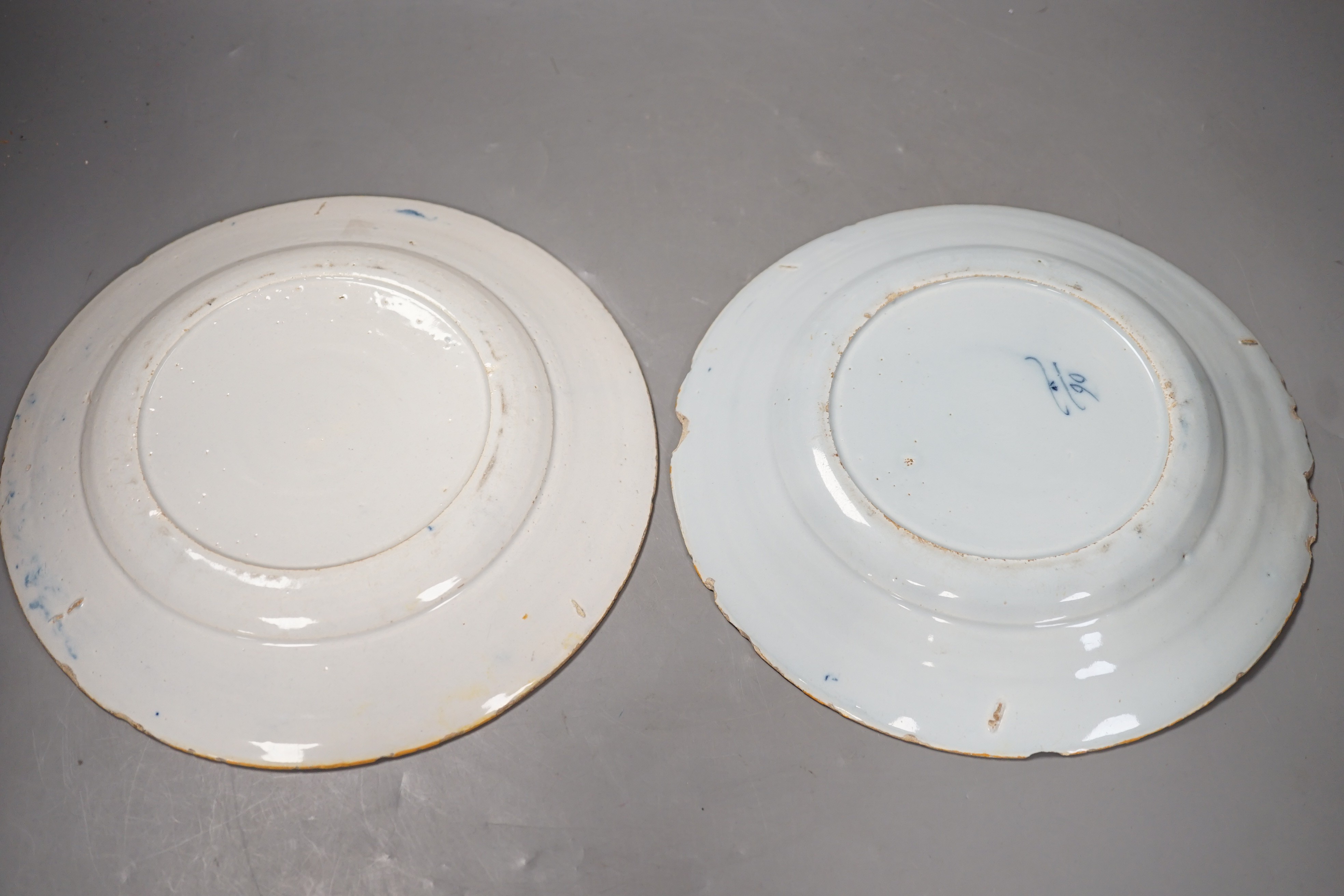 Two 18th century Dutch Delft blue and white plates, largest 23cms diameter